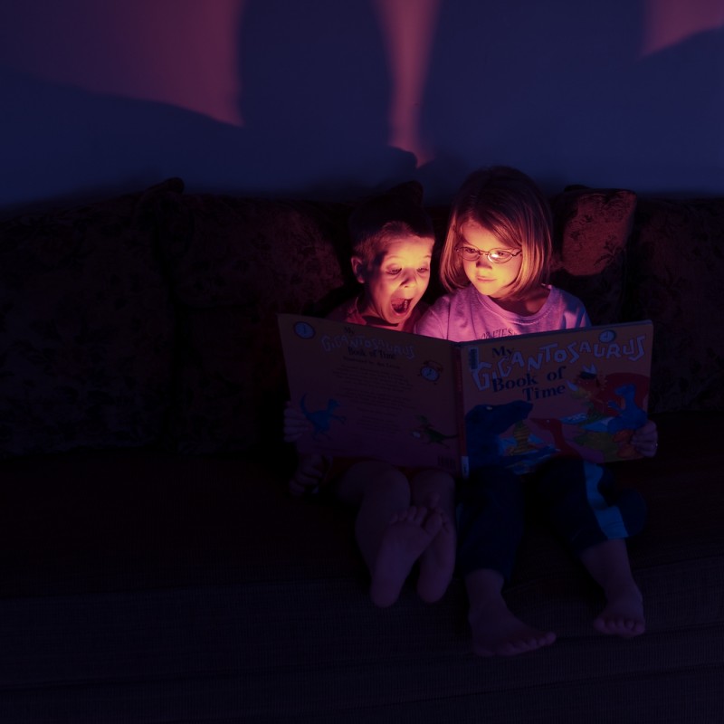 Surprised Children Reading a Book Together